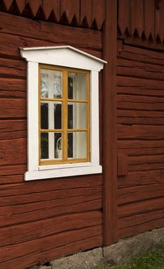 a window on the side of a wooden building