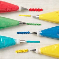 six different colored pens with plastic caps on them