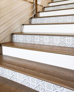 some white and brown stairs with wooden handrails