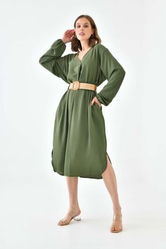 Oversized Long Sleeves V Neck Midi Dress with Matching Belt is the perfect combination of effortless style and sass, crafted from a lightweight fabric so you can stay comfortable all day long. It features a classic v-neckline, long sleeves and stylish belt detail that adds an on-trend finish to this dress.  Whether you're headed for a party or simply want to look your best, this midi dress will have you feeling confident and beautiful! SPECS: Material: Viscose Color: Khaki Fit: Relaxed Size: Oversized *Suitable for UK size 8-16 Product Highlight: ● Oversized fit with details. ● Versatile design. ● Suitable for various occasions. ● Flattering fit. ● A versatile addition to your wardrobe. 💦CARE INSTRUCTIONS: ● Check the care label for instructions. ● Pre-treat stains before washing. ● Machi Casual Solid Long Sleeve V-neck Dress, Oversized V-neck Midi Dress For Daywear, Flowy V-neck Midi Dress For Work, Green Relaxed Fit V-neck Midi Dress, Green V-neck Relaxed Fit Midi Dress, Green V-neck Midi Dress With Relaxed Fit, Solid Color V-neck Midi Dress For Work, Casual V-neck Dress With Split Neck, Oversized Green V-neck Dress