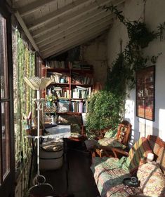 the sun shines through an open room with bookshelves and couches in it