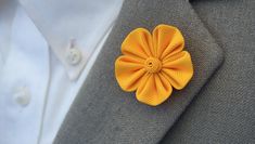 "Handmade 5 Petal Golden-Yellow Kanzashi Flower lapel Pin Size: 1.5\" for the flower 3\" overall A great accessory for suits, sweaters, coats, even hats! This purchase is for one 5 petal golden yellow lapel pin. We offer this listing with either clutch back or lapel pin. If you would like to order more than one for a wedding or other special event, please message me and I will gladly accommodate any requests. Each one of our lapel flowers is handmade and unique. So even though your order will be Elegant Yellow Flower Brooches, Handmade Flower Shaped Brooches For Formal Occasions, Formal Handmade Flower Brooches, Elegant Yellow Brooches For Gifts, Boutonniere Groomsmen, Brooch Boutonniere, Lapel Flowers, Coat Pin, Flower Lapel