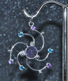 "This nebula small pendant in sterling silver with amethyst, titanium druzy quartz and apatite swirls with the whirlwind motion of space dust, space clouds and space ions. Amethyst, apatite and the beauty of fine quartz crystals coated with anodized titanium is just the right galactic combo of elements. This light and bright eye-catching piece will be a constant reminder that you are made of star stuff! This pendant is 1 1/8\" (28 mm) from top to bottom and 1\" (25 mm) at the widest point. At th Celestial Silver Jewelry With Sparkling Stones, Celestial Style Silver Jewelry With Sparkling Stones, Celestial Multi-stone Sterling Silver Jewelry, Silver Celestial Multi-stone Jewelry, Silver Multi-stone Celestial Jewelry, Purple Fusion Style Round Jewelry, Silver Spiral Gemstone Jewelry, Purple Sterling Silver Fusion Jewelry, Hypoallergenic Silver Amethyst Jewelry