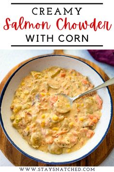 creamy salmon chowder with corn in a blue and white bowl on a wooden board