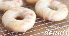 four glazed donuts sitting on top of a cooling rack with the words, 2 ingredient air fryer donuts