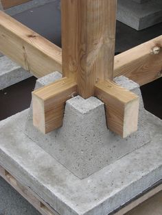 some concrete blocks and wooden posts on the ground