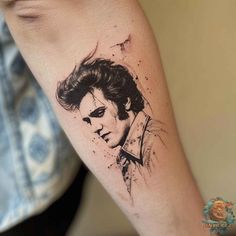 a man's arm with a tattoo on it that has the image of elvis presley