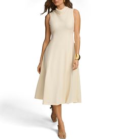 a woman wearing a white dress and gold accessories is standing in front of a white background