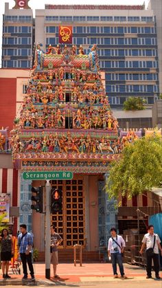 people are standing in front of a colorful building