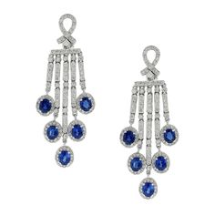 Sophisticated elegance! These earrings feature 5.43 carats of oval shape blue sapphires accented by 2.09 carats of round cut diamonds. These chandelier drop earrings are set in 18K white gold with omega clip backings. Earring Length: 2.15 inches Earring Width: 0.75 inches Sapphire Drop Earrings, Dance Earrings, Light Blue Sapphire, Diamond Chandelier, Gold Chandelier Earrings, Sapphire And Diamond Earrings, Colorless Diamond, Blue Sapphire Diamond, Long Drop Earrings