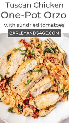 chicken with sundried tomatoes and spinach pasta in a white bowl on a table