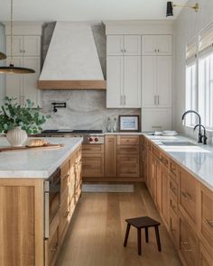 a kitchen with wooden cabinets and white counter tops