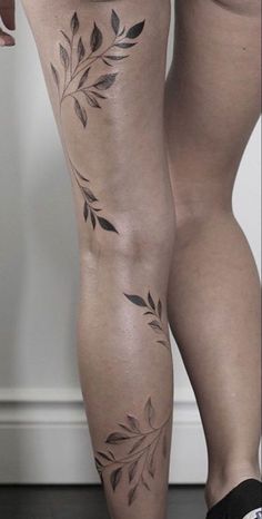 a woman's legs with tattoos on them