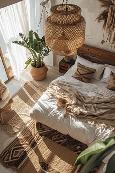 a bed with white sheets and pillows in a bedroom next to a potted plant