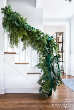 the garland on the stairs is decorated with greenery