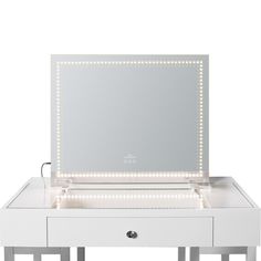 an illuminated vanity table with mirror and lights on it's sides, in front of a white background