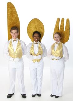 three people in white pants and gold vests