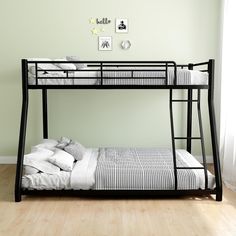 a black metal bunk bed sitting on top of a hard wood floor next to a window