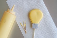 a yellow toothbrush sitting on top of a white napkin