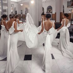 the brides are getting ready to walk down the aisle in their wedding gowns