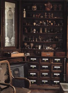 an old wooden cabinet with many items on it