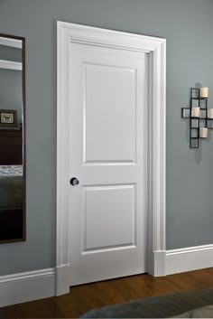 a white door in a room with blue walls