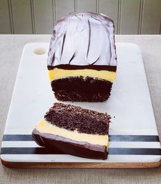 a piece of cake sitting on top of a white plate next to a slice of chocolate cake