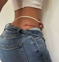 a woman's stomach with the word love spelled on her lower back and side