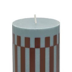 a white and brown striped candle with a single stick in it's center, on a white background