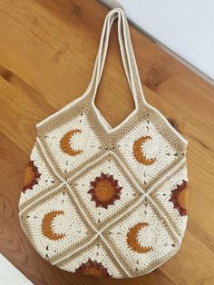 a crocheted bag sitting on top of a wooden floor