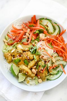 a white bowl filled with lots of veggies and meat