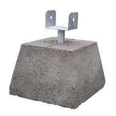 a concrete block with two metal brackets on the top and one is attached to it