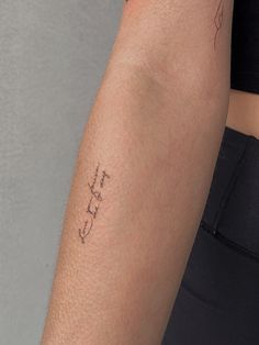 a woman's arm with the word love written in cursive writing on it