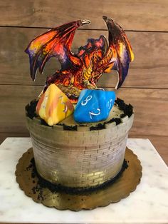 a cake decorated with dice and a dragon figurine