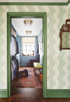 the hallway is decorated with green trim and wallpaper