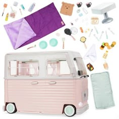 a pink and white vw camper van with accessories surrounding it