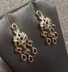 Vintage 10k Yellow Gold Amethyst & Diamond Chandelier Earrings The earrings measure 1-3/8" in length and weigh 5.3 Grams. Each earring is marked 10K on the back. In good vintage condition Will ship in a gift box. Stock #E2641 As with all jewelers, I do enlarge pictures of the jewelry.  This is to your advantage, so you can see all details more clearly.  I do provide measurements of the jewelry, so be sure to read the description to better understand the true size of the item. Please review the m Purple Drop Chandelier Earrings For Formal Occasions, Elegant Purple Dangle Chandelier Earrings, Elegant Purple Gemstone Chandelier Earrings, Elegant Gold Chandelier Earrings With Amethyst, Elegant Gold Amethyst Chandelier Earrings, Hallmarked Dangle Chandelier Earrings For Anniversary, Purple Gemstone Chandelier Drop Earrings, Purple Gemstone Chandelier Earrings, Gold Amethyst Dangle Chandelier Earrings