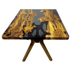 a black and gold table with wooden legs