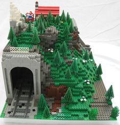 a lego model of a castle with trees and animals