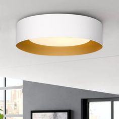 a white and gold ceiling light in a living room