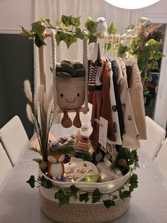 an arrangement of clothing and accessories is displayed on a table in front of a window