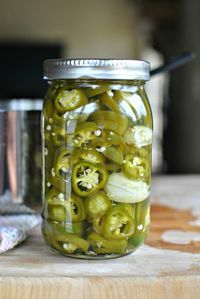 pickled green peppers and onions in a mason jar