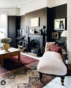 a living room filled with furniture and a fire place in the middle of a room