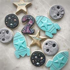 the cookies are decorated with blue and white icing, which have stars on them