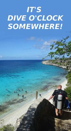 a man standing on top of a stone wall next to the ocean with text overlay that reads it's dive o'clock somewhere