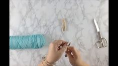 someone is working on some crafting supplies with yarn and scissors in front of them