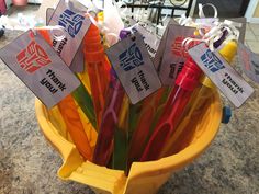 a yellow bucket filled with lots of different colored markers