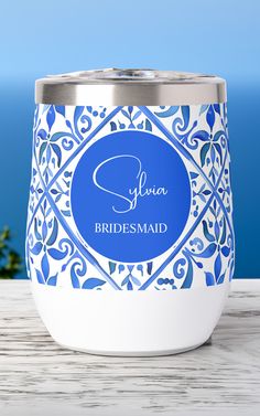 a blue and white wedding candle holder with the name julia bridesmaid on it