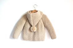 Hand Knitted Baby Wool Hoodie Cardigan/Jacket, Chunky, Duffel Coat, Raglan with Pom Pom This cardigan is made from %75 wool yarn and %25 premium acrylic, anti-allergic. This cardigan is hand made, really warm and perfect for winter. %100 Hand Knitted This picture color is Sand Beige 23116 You can find the color list and number in the photos. The picture size is: 12-18 months Measurements: Full lenght : 12.6'' (32 cm) Finished chest : 25'' (64 cm) Sleeve Lenght : 14.5'' (37 cm) Easy dressing and Hooded Knitted Beige Cardigan, Beige Knitted Hooded Cardigan, Beige Knitted Hooded Outerwear, Beige Hooded Knitted Cardigan, Beige Hooded Knitted Outerwear, Cream Hand Knitted Long Sleeve Outerwear, Duffel Coat, Knit Sweater Outfit, Wool Hoodie