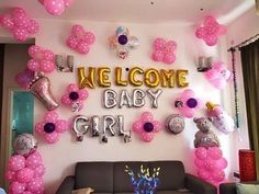 a welcome baby girl party with balloons and teddy bears on the wall, along with other decorations